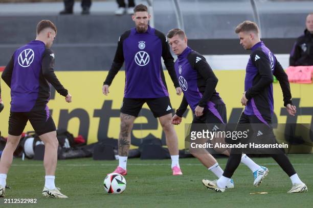 Joshua Kimmich, Robert Andrich, Toni Kroos and Maximilian Mittelstädt of Germany pla with the ball during a training session of Team Germany at DFB...