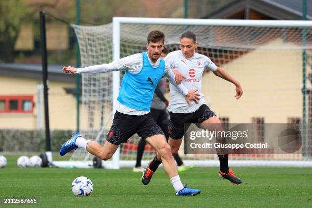 Matteo Gabbia of AC Milan competes for the ball with Dariusz Piotr Stalmach during an AC Milan Training Session at Milanello on March 25, 2024 in...