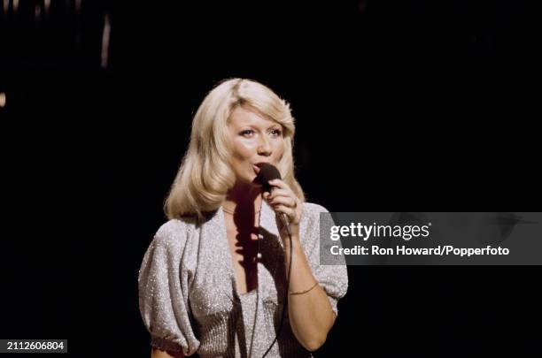 Northern Irish singer Clodagh Rodgers performs on the set of a pop music television show in London circa 1970.