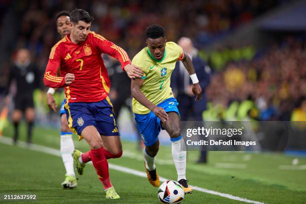 Vinicius Junior of Brazil and Alvaro Morata of Spain battle for the ball during the friendly match between Spain and Brazil at Estadio Santiago...