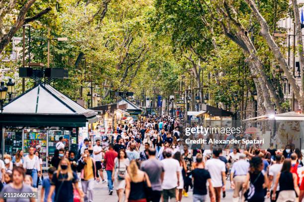 la rambla pedestrian street with crowds of tourists, barcelona, spain - pedestrian zone stock pictures, royalty-free photos & images