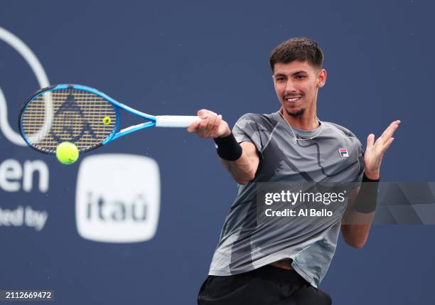 Fabian Marozsan of Hungary returns a shot against Alexei Popyrin of Australia during their match on Day 10 of the Miami Open at Hard Rock Stadium on...