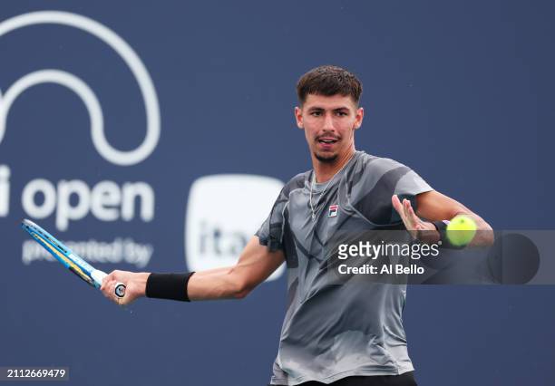 Fabian Marozsan of Hungary returns a shot against Alexei Popyrin of Australia during their match on Day 10 of the Miami Open at Hard Rock Stadium on...