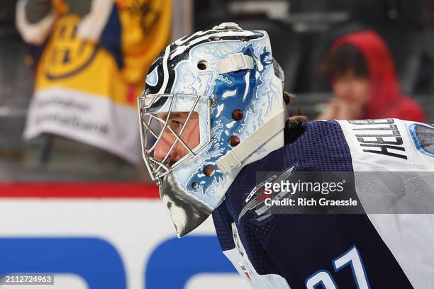 Connor Hellebuyck of the Winnipeg Jets warms up prior to the game against the New Jersey Devils at the Prudential Center on March 21, 2024 in Newark,...