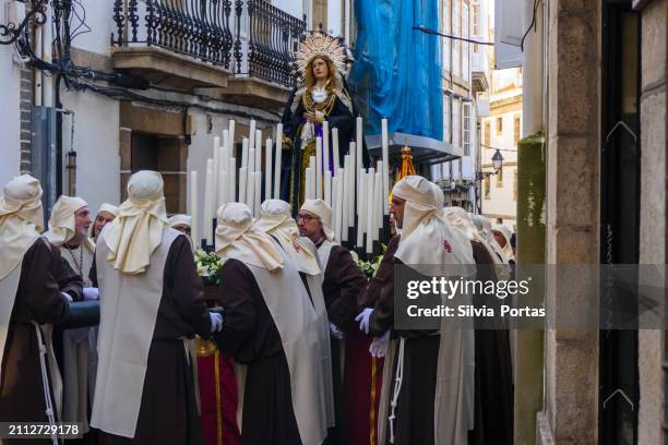 hombres de una cofradía religiosa portando a la virgen marchando por la calle durante la semana santa en la coruña, galicia, españa - semana santa fotografías e imágenes de stock