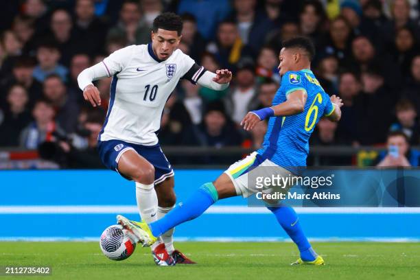 Jude Bellingham of England in action with Wendell of Brazil during the international friendly match between England and Brazil at Wembley Stadium on...