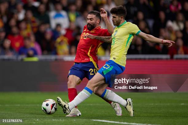 Dani Carvajal of Spain and Lucas Lopes Beraldo of Brazil battle for the ball during the friendly match between Spain and Brazil at Estadio Santiago...