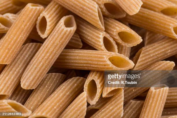wholegrain penne pasta - vollkorn stock pictures, royalty-free photos & images