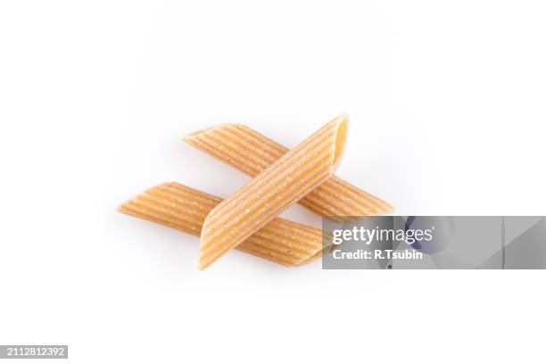 wholemeal pasta penne as close-up shot isolated on white background - vollkorn stock pictures, royalty-free photos & images