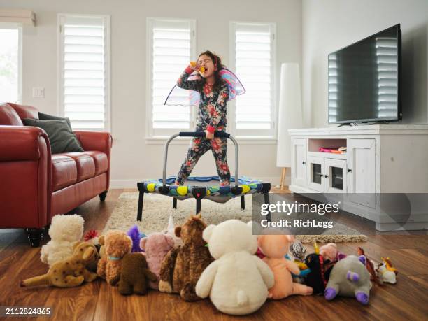 preschooler playing a make-believe concert - gig living room stock pictures, royalty-free photos & images