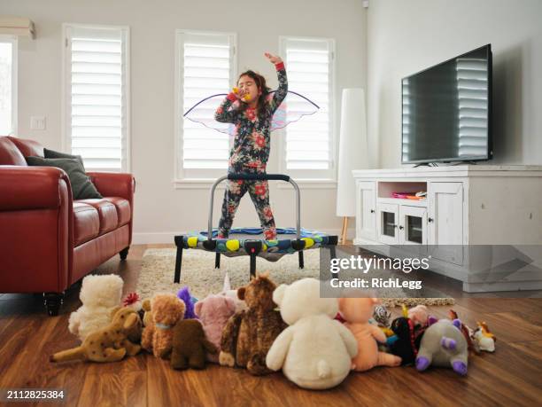 preschooler playing a make-believe concert - gig living room stock pictures, royalty-free photos & images