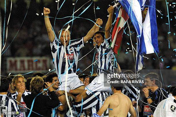 Real Sociedad Turk Tayfun and Russian Dimitri Kohklov celebrate their team's taking second position in the Spanish Soccer League, beating Atletico de...