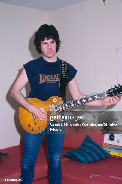 Portrait of guitarist Gary Moore with his Gibson Les Paul Standard guitar at a hotel, Tokyo, Japan, January 1983.