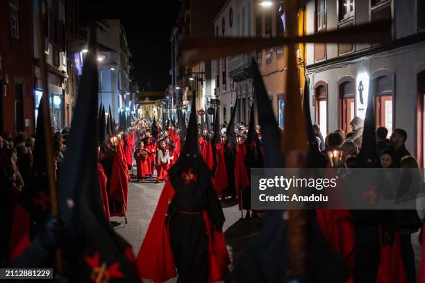 Members of 'Muy Antigua y Venerable Hermandad de la Sangre de Cristo y de la Santa Cruz' brotherhood, march in procession during Holy Week in the...
