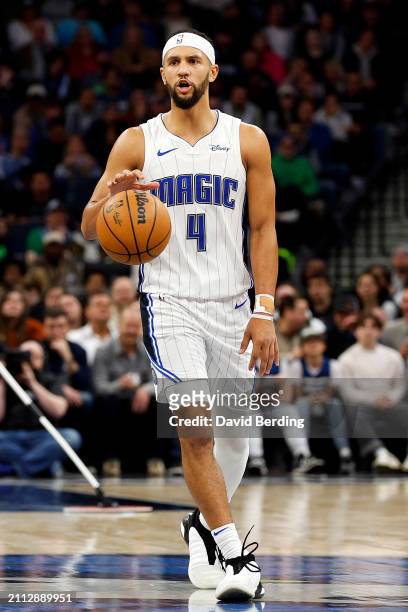 Jalen Suggs of the Orlando Magic dribbles the ball against the Minnesota Timberwolves in the fourth quarter at Target Center on February 02, 2024 in...