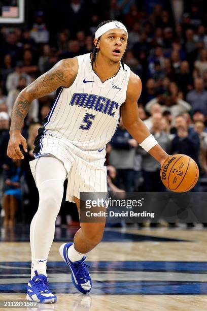 Paolo Banchero of the Orlando Magic dribbles the ball against the Minnesota Timberwolves in the fourth quarter at Target Center on February 02, 2024...