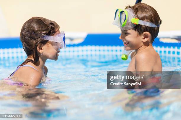 children games in swimming pool - child swimming stock pictures, royalty-free photos & images