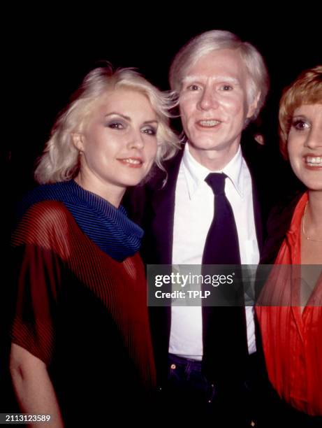 American musician Debbie Harry , of the American rock band Blondie, American visual artist Andy Warhol and American actress Lorna Luft attend a party...