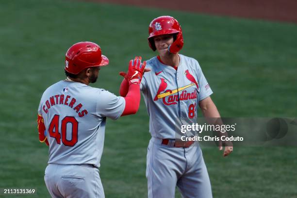 Willson Contreras high fives R.J. Yeager of the St. Louis Cardinals after hitting a two run home run during the sixth inning of a spring training...