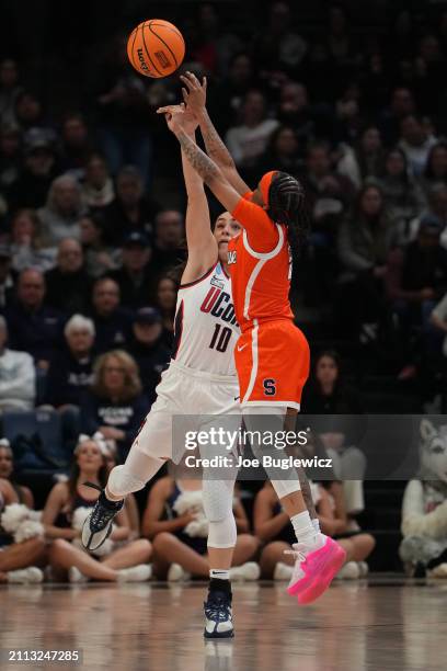 Nika Muhl of the Connecticut Huskies gets the block on Dyaisha Fair of the Syracuse Orange during the first half of a second round NCAA Women's...