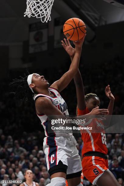 Arnold of the Connecticut Huskies os defended by Kyra Wood of the Syracuse Orange during the first half of a second round NCAA Women's Basketball...