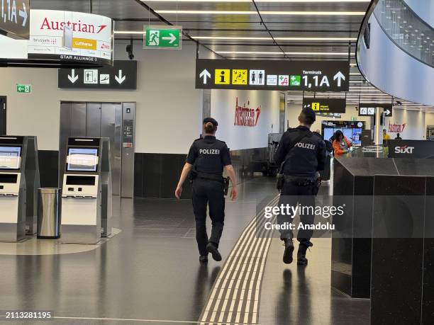 Police officers are seen at the Schwechat International Airport as cabin crews working at Austrian Airlines go on strike after 17 salary negotiations...