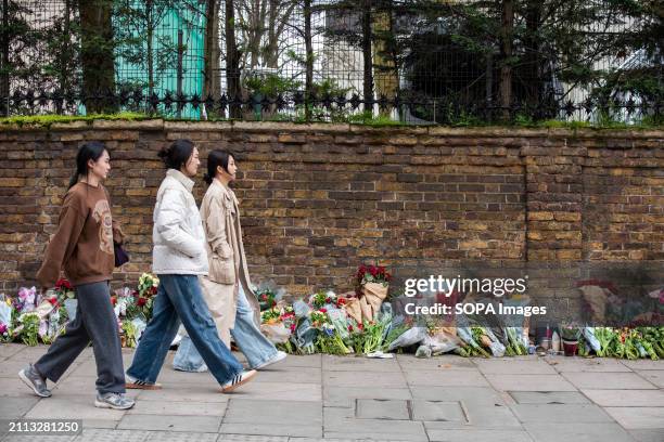 Pedestrians walk past the flowers outside the Russian Embassy in London. Russian diasporas are mourning in London, UK because of the deadly terrorist...
