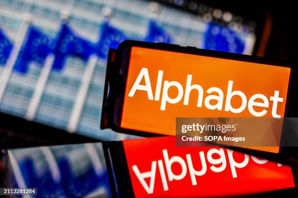 In this photo illustration, an Alphabet logo seen on a smartphone and tablet screens against a screen displaying a photograph of European Union...