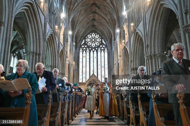 Britain's Queen Camilla and Interim Dean of Worcester Cathedral The Reverend Canon Dr Stephen Edwards arrive for the Royal Maundy Service where The...