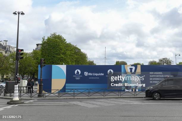 Hoarding featuring the logos of the Paris 2024 Olympic and Paralympic games and Air Liquide SA close to a hydrogen fueling station in Place de l'Alma...