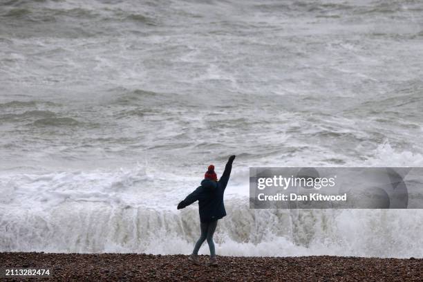 Person watches the big waves as Storm Nelson batters the coastal regions on March 28, 2024 in Brighton, England. Storm Nelson had already hit parts...