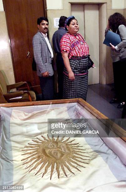 The indiginous Guatemalan leader, Rigoberta Menchu, winner of the Nobel Peace Prize in 1992, waits next to a collaborating group, for meeting with...