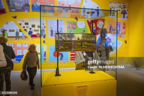 Visitors pass by the "Spring Garden" painting by Vincent van Gogh during the press preview of the exhibition titled "Behind the Scenes" to mark the...