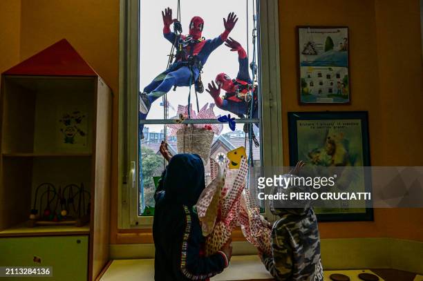 People dressed as Superheroes deliver Easter eggs to children hospitalised in the pediatric ward of the De Marchi clinic, on March 28, 2024 in Milan,...