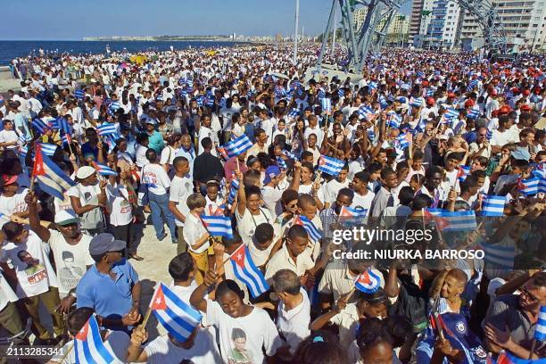 Cubans demonstrate 20 April in front of the office of the US Interests Section in Havana for the return of six-year-old Elian Gonzalez. The...