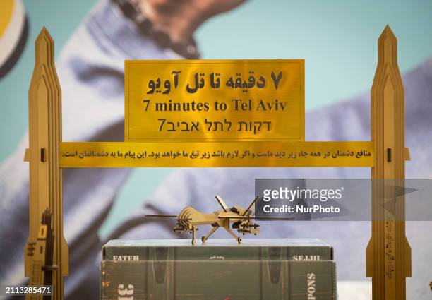 Models of Iranian missiles and a drone are being placed under an anti-Israeli placard in the Imam Khomeini Grand Mosque during the 31st edition of...
