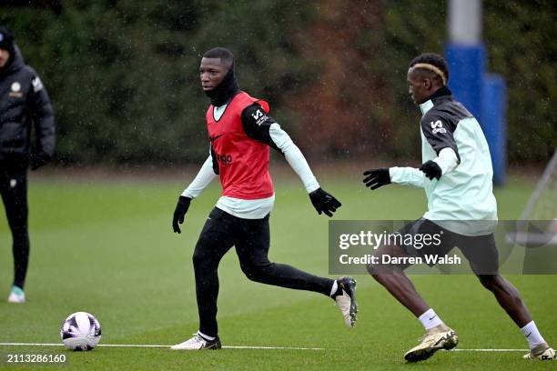 Moises Caicedo and Nicolas Jackson of Chelsea during a training session at Chelsea Training Ground on March 28, 2024 in Cobham, England.