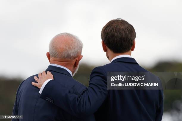 France's President Emmanuel Macron and Brazil's President Luiz Inacio Lula da Silva pose for a picture after a bilateral meeting at the Planalto...