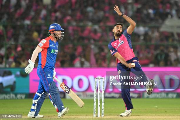 Rajasthan Royals' Avesh Khan bowls as Delhi Capitals' David Warner looks on during the Indian Premier League Twenty20 cricket match between Delhi...