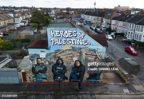 An aerial view of a mural made by street artists Auberi Chen, Core 246 and Captain Kris depicting Palestinian photographers Mohammed Al-Masri , Ali...