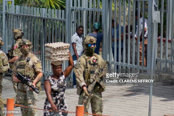 Canadian soldiers stand guard in front of their embassy in Port-au-Prince on March 28 2024. The situation in chaos-wracked Haiti is "cataclysmic",...