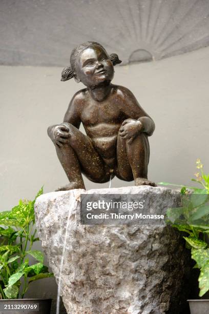 The statue of Jeanneke Pis, commissioned by Denis-Adrien Debouvrie in 1985, representing a naked little girl with short pigtails, squatting and...