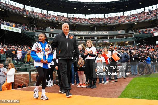 Aubree Singletary, the child of a Baltimore City postal worker, and Hall of Famer and member of the new ownership group Cal Ripken Jr. Take the field...