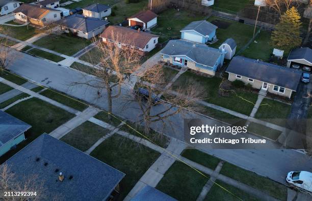 Police tape surrounds several houses as police investigate a mass stabbing along the 2300 block of Holmes Street on March 27 in Rockford, Illinois.