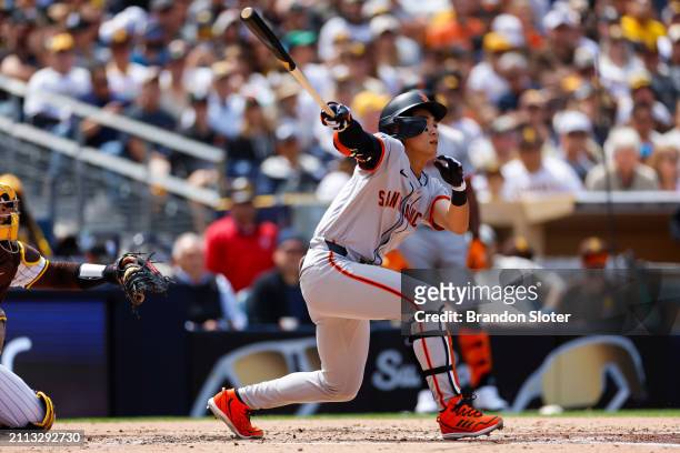 Jung Hoo Lee of the San Francisco Giants hits a line out in the third inning during an Opening Day game against the San Diego Padres at PETCO Park on...