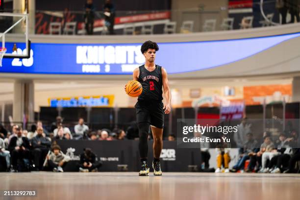 Cayden Boozer of the Columbus Explorers dribbles the ball the game against the Notre Dame Knights during The Throne high school basketball tournament...