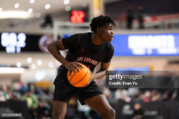 Malik Abdullahi of the Columbus Explorers handles the ball during the game against the Notre Dame Knights during The Throne high school basketball...