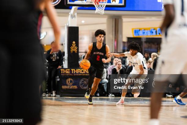 Cayden Boozer of the Columbus Explorers dribbles the ball the game against the Notre Dame Knights during The Throne high school basketball tournament...