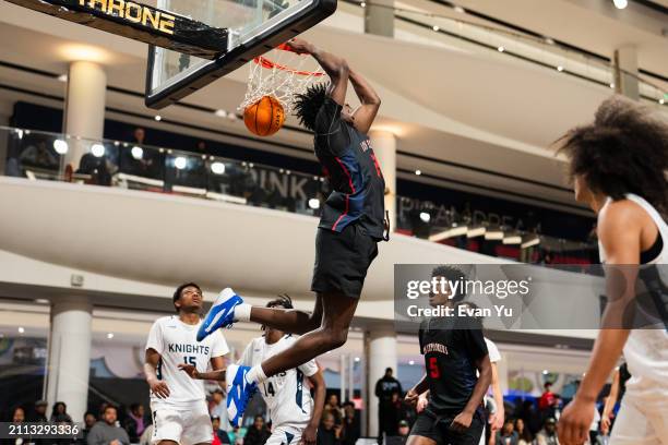 Malik Abdullahi of the Columbus Explorers dunks the ball during the game against the Notre Dame Knights during The Throne high school basketball...
