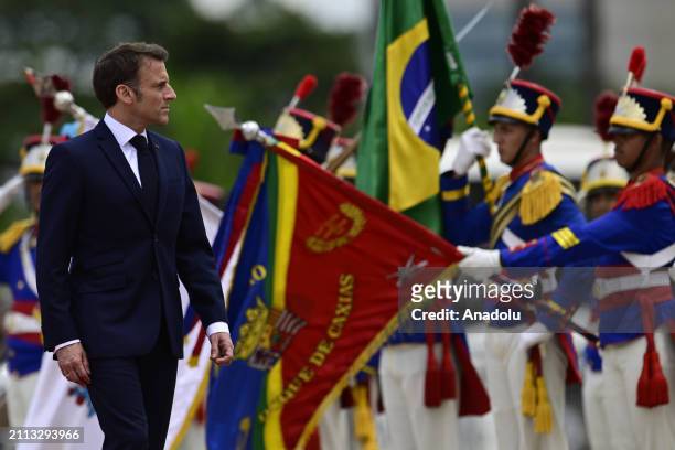 French President Emmanuel Macron walks ahead of the meeting with Brazil's President Luiz Inacio Lula da Silva at the Planalto Palace in Brasilia,...